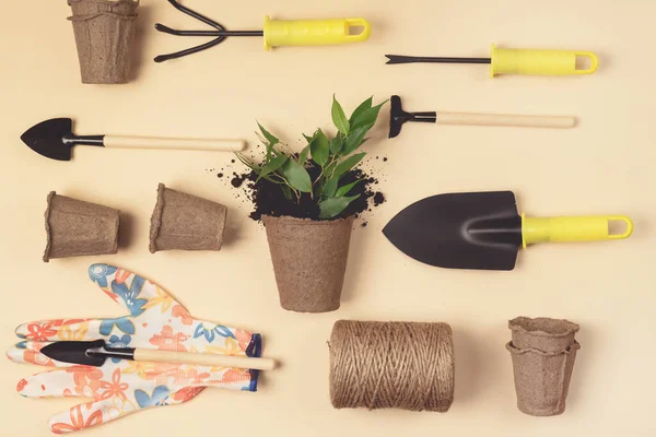 Flat Lay with Garden Tools Gardening Spring or Summer Concept Yellow Gloves Garden Shovel Rake and Thread are Lying on Yellow Background Top View Horizontal