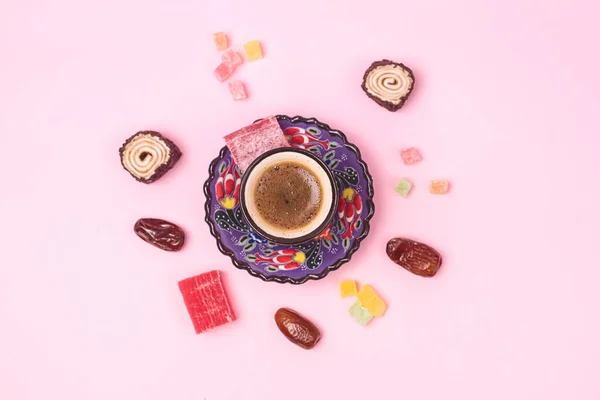 Turkish Delight Turkish Coffee Date Fruit and Garnet on Black Round Tray Pink Background Top View Ramadan