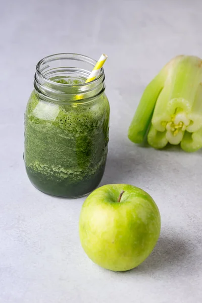 Glass Jar of Healthy Green Smoothie Detox Drink wirh Green Apple Celery and Raw Spinach Diet Beverage Vertical