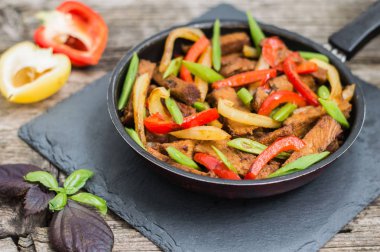 Bir tavada sebze sote sığır eti. Ahşap arka plan. Üstten Görünüm. Yakın çekim