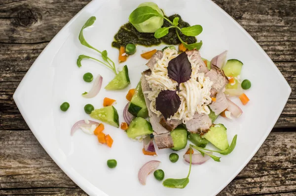 Sallad med hackad bakad kött, smält ost, gurka, morot och ärtor puré. Trä bakgrund. Närbild — Stockfoto