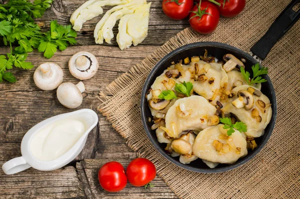 Dumplings with cabbage, fried mushrooms and cream sauce — Stock Image Dumplings with cabbage, fried mushrooms and cream sauce Stock Image