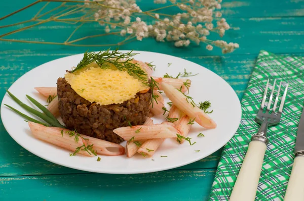 Rakott hús, olasz tészta és a sajt chips. Fából készült háttér. Közeli kép: — Stock Fotó