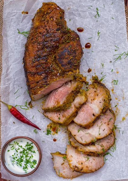 Bife de porco cozido na grelha, marinado em ervas e alecrim, servia uma mesa com molho tzatziki. Papel de fundo para assar. Vista superior. Close-up — Fotografia de Stock