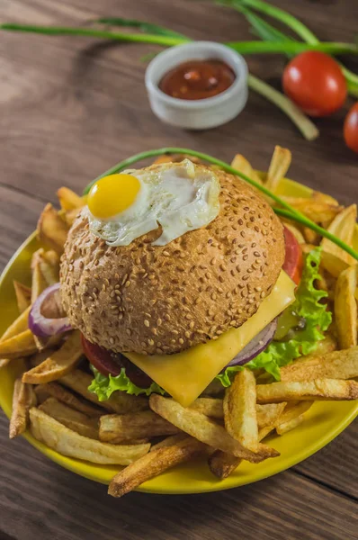 Büyük sandviç - sığır eti, peynir, domates ile hamburger burger. Ahşap rustik arka plan üzerinde. Üstten Görünüm. Yakın çekim