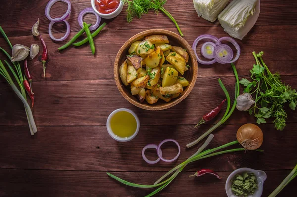 Batatas assadas com legumes e ervas em um fundo de madeira, vista superior. Close-up — Fotografia de Stock