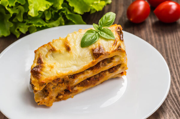 Lasagna, traditional Italian food on a wooden background
