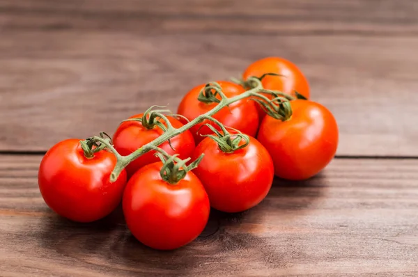 Detailní cherry rajčátky na dřevěné pozadí — Stock fotografie