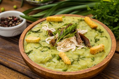 Çorba bezelye, eritilmiş peynir, kavrulmuş et, kruton ve otlar ile püre. Ahşap arka plan. Üstten Görünüm. Yakın çekim