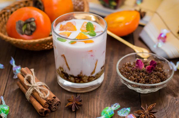 Fruta fresca cortada, caqui sobre yogur de miel — Foto de Stock