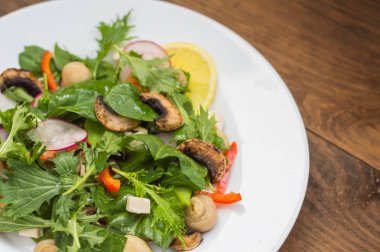 Turp, Mizuno, taze bahar salatası mantar ızgara, Adygei peynir, ıspanak, biber, limon, Mısır. Ahşap arka plan