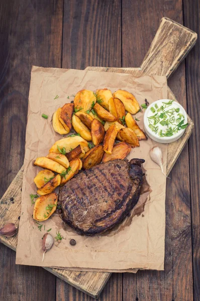 Rustic grilled beefsteak with french fries — Stock Photo, Image