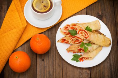 Rulo krep kırmızı havyar ile. Rus yemekleri. Düz yatıyordu. Maslenitsa. Ahşap arka plan. Üstten Görünüm. Yakın çekim