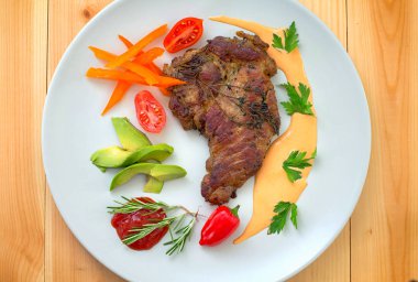 Izgara domuz biftek ve ızgara sebze. Yatay, rustik tarzı. Ahşap arka plan. Yakın çekim. Üstten Görünüm