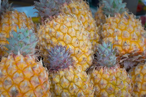 Fresh pineapples at fruit market. Top view. Close-up — Stock Photo, Image