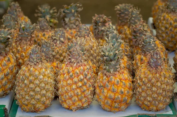 Fresh pineapples at fruit market. Top view. Close-up — Stock Photo, Image