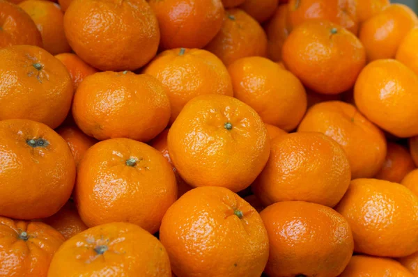 Fresh mandarin oranges texture. Mandarin for sale on market. Agriculture background. Close-up. Top view
