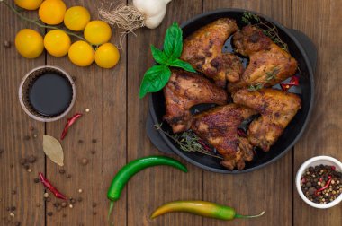 Tavuk kanadı pişirme tavada pişirdim. Seçici odak. Ahşap arka plan. Yakın çekim. Üstten Görünüm