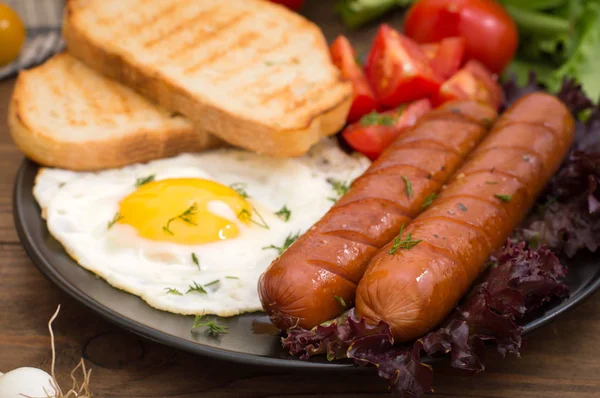 İngiliz kahvaltısı - ekmek, yumurta, sosis ve sebze salatası. Ahşap rustik arka plan. Yakın çekim. Üstten Görünüm — Stok fotoğraf