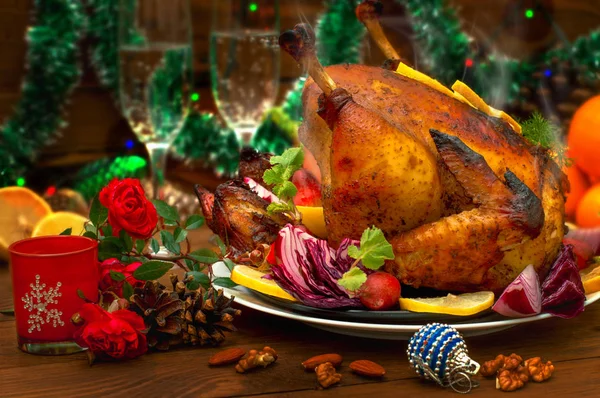 Christmas Dinner. Roasted chicken. Winter Holiday table served. Wooden background. Close-up. Top view