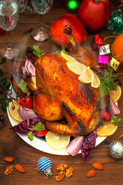Christmas Dinner. Roasted chicken. Winter Holiday table served. Wooden background. Close-up. Top view