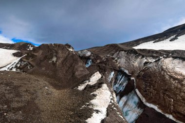 Volcanic landscape. Glacier in the Avacha Pass of Kamchatka Peninsula. Russia, Far East clipart