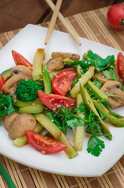 Salad with mushrooms, avocado, cauliflower, tomatoes and greens. Wooden rustic background. Top view — Stock Photo, Image