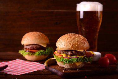Taze hamburger closeup ve bira. Ahşap rustik arka plan. Üstten Görünüm