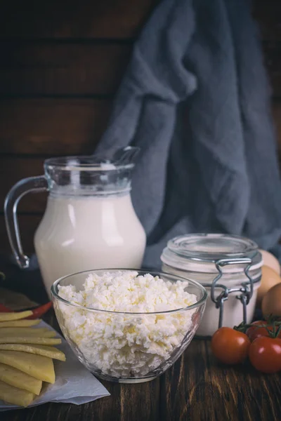 Farmers food products: milk, cream, cheese, eggs, cottage, butter. Rustic composition. Organic food concept