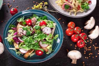 Izgara tavuk göğsü - domates, turp ve karışım marul yaprakları taze sebze salatası. Tavuk salatası. Sağlıklı gıda. Siyah arka plan. Üstten Görünüm