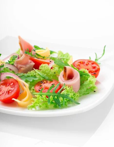 Fresh salad with tomatoes, arugula, cheese and ham on the white plate and white background — Stock Photo, Image