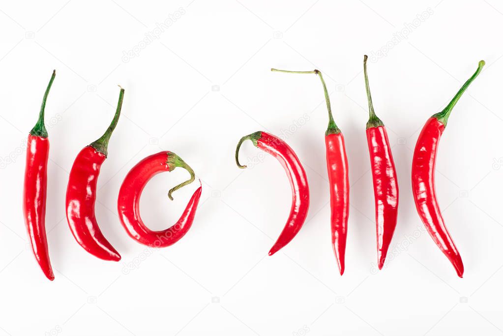 Raw organic chili on the white background. Vegan or diet food concept. Background layout with free text space