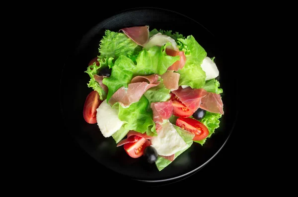 Fresh tasty salad on a glossy black background — Stock Photo, Image