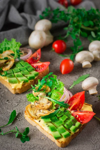 Panino tostato fatto in casa con avocado e funghi su piatto bianco. cibo sano — Foto Stock