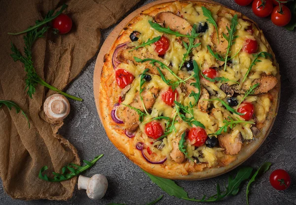 Pizza con pollo, rucola, formaggio e cipolle su tavolo rustico in legno. Vista dall'alto — Foto Stock