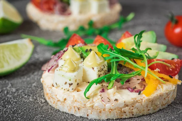 Bruschetta with tomato, avocado, herbs and arugula. Rustic background. Top view — Stock Photo, Image