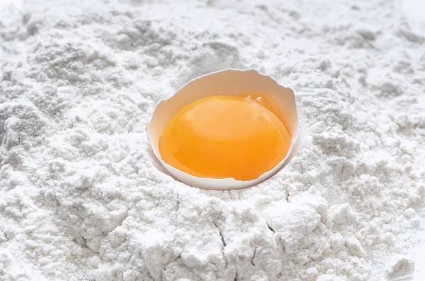 Fresh egg in wheat flour isolated on white background as package design element. Top view — Stock Photo, Image