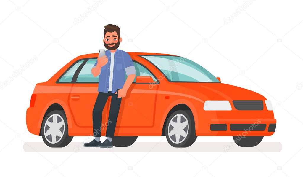 Happy man is standing next to the car and looking at the screen 