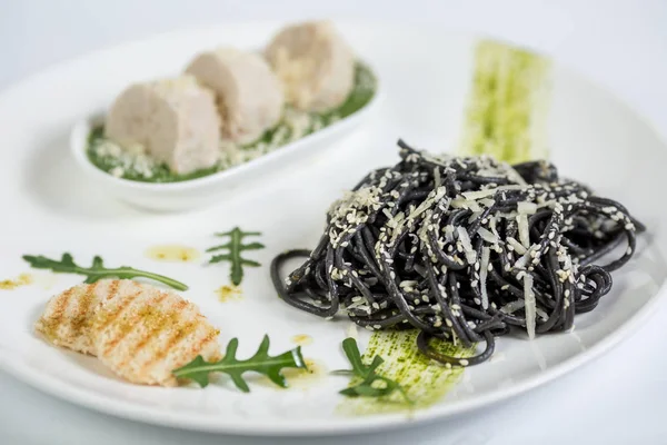 Spageti hitam dengan pasta pada latar belakang putih — Stok Foto