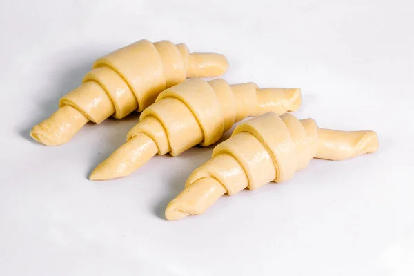 Three raw croissant before baking isolated on white background — Stock Photo, Image