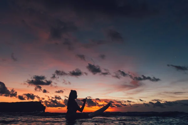 Surfer girl at sunset — Stock Photo, Image