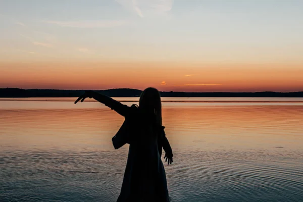 Female silhouette with raised hand — Stock Photo, Image