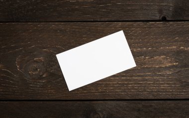 Stack of blank white business cards on dark chocolate wooden background . Pile of empty Horizontal identity empty papers for template or mockup. clipart