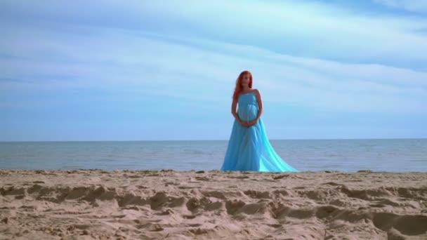 Playa de mujeres embarazadas. Playa embarazada. Mujer embarazada en vestido azul en la playa de mar — Vídeo de stock