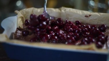 Kiraz için çikolatalı kek kaşıkla ekleyerek Şef. Pasta madde