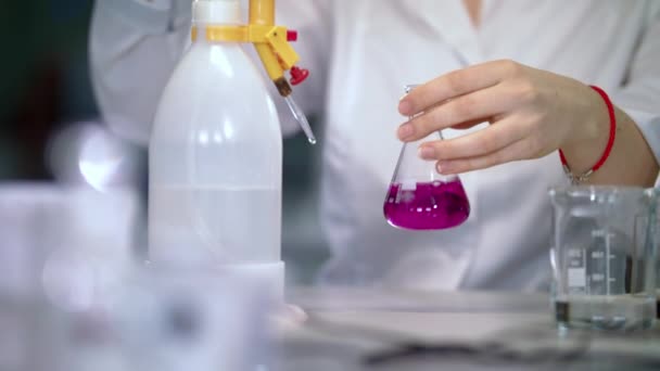 Ученые работают с жидкостью в медицинской лаборатории. Посуда в руках врача — стоковое видео