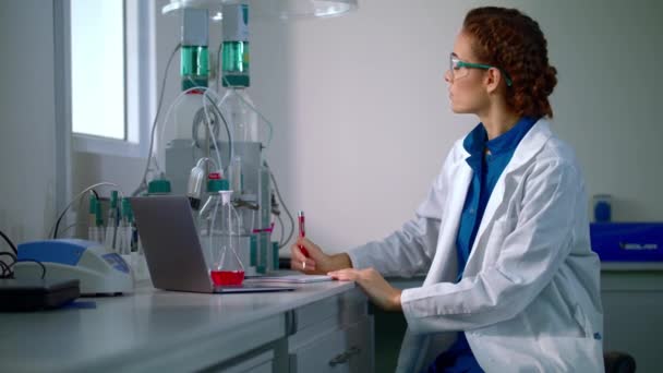 Young scientist writing results of research. Laboratory scientist working — Stock Video