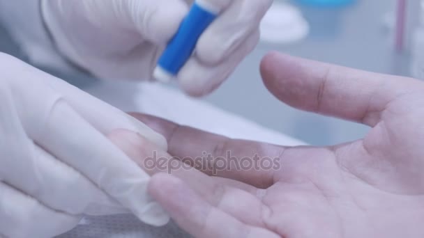 Doctor hand take blood test from patinent finger at lab. Close up of blood test — Stock Video