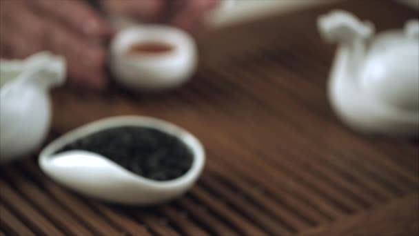 Traditional chinese tea ceremony. Close up of female hand set chinese tea cup — Stock Video
