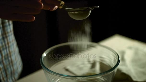 Man hand ta sikten och sållar mjöl i glasskål. Pulver mjöl i glasskål — Stockvideo